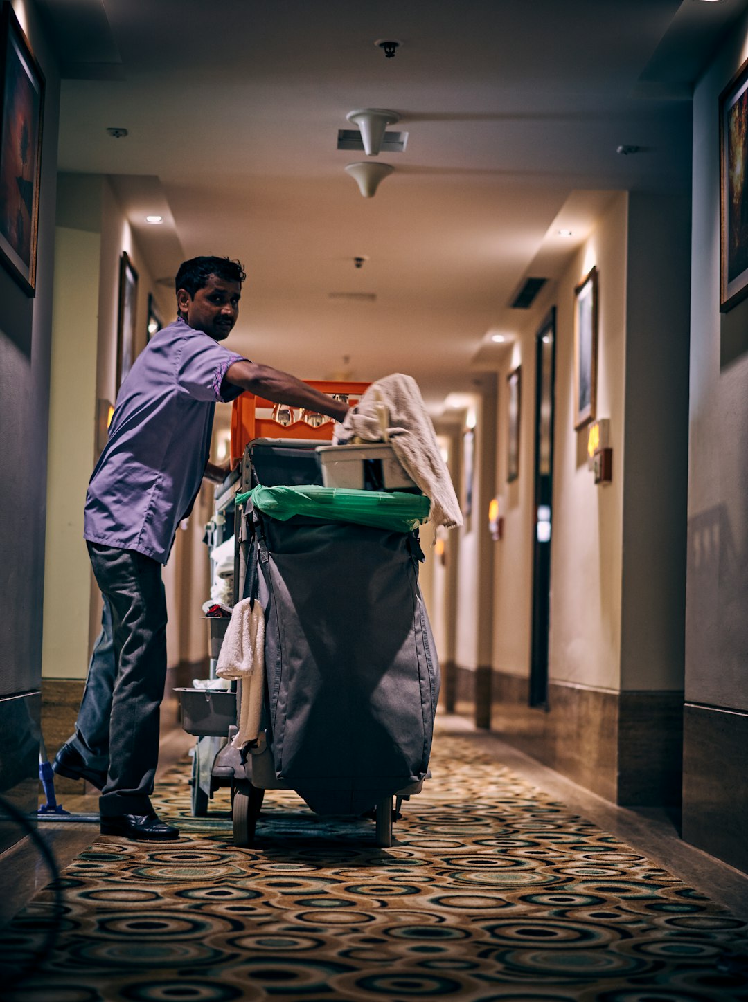 about-04 Hotel corridor cleaning staff member with his equipment